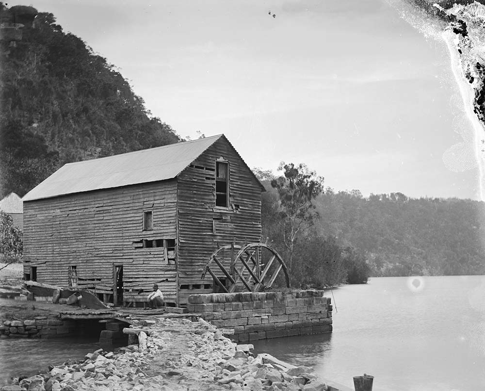 A photograph by William Hall of Singletons  flour mill and its old waterwheel at Layburys Creek, Wisemans Ferry NSW