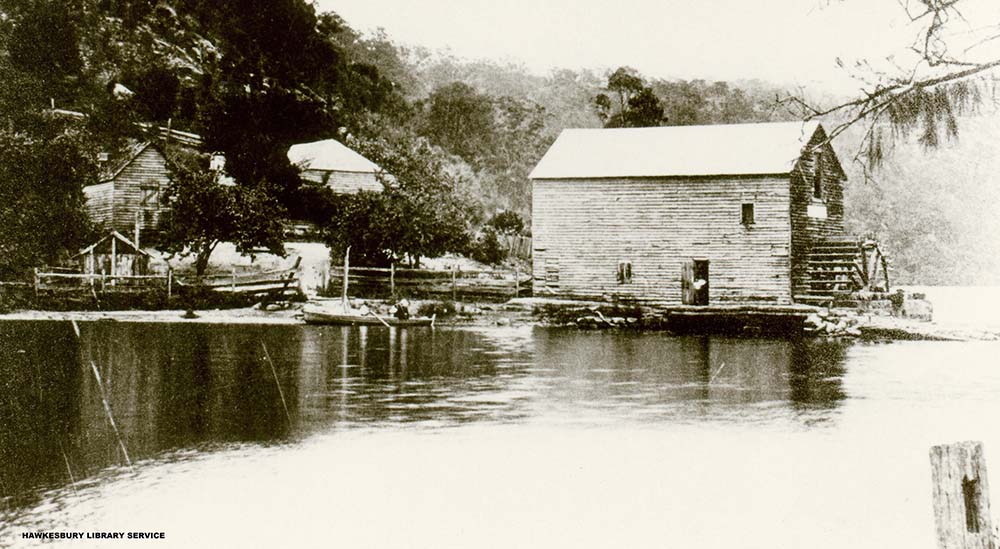 A photograph of Singletons Watermill at Layburys Creek, Wisemans Ferry showing the waterwheel and mill pond