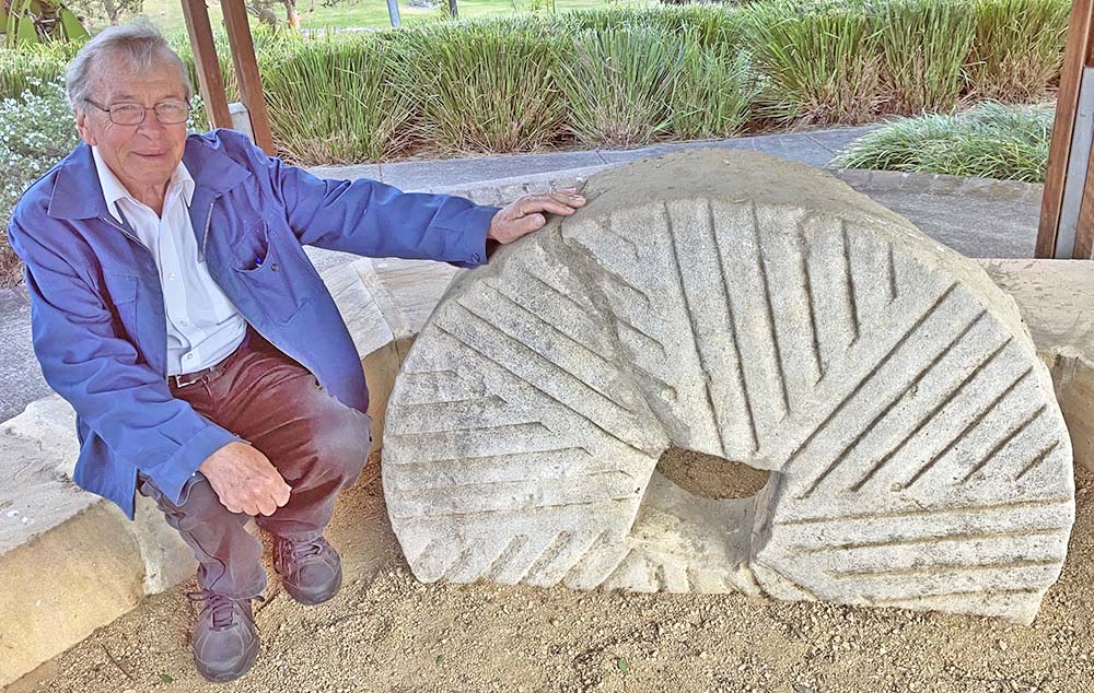 Les Dollin, researching the mills built by the Singleton Family - shown here with one of Benjamin Singleton's millstones from Kurrajong. sh